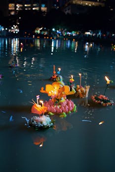 Floating krathongs with candles illuminate the water during the Loy Krathong festival in Bangkok, Thailand.