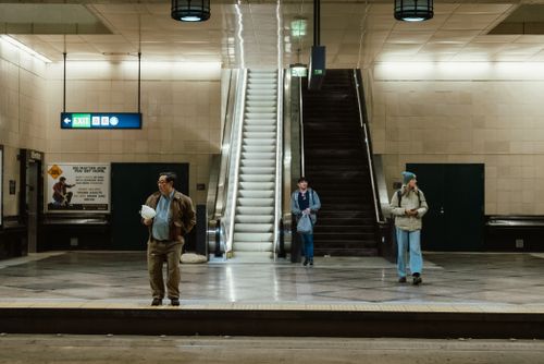 Free Three people in an underground Seattle station during the day. Stock Photo