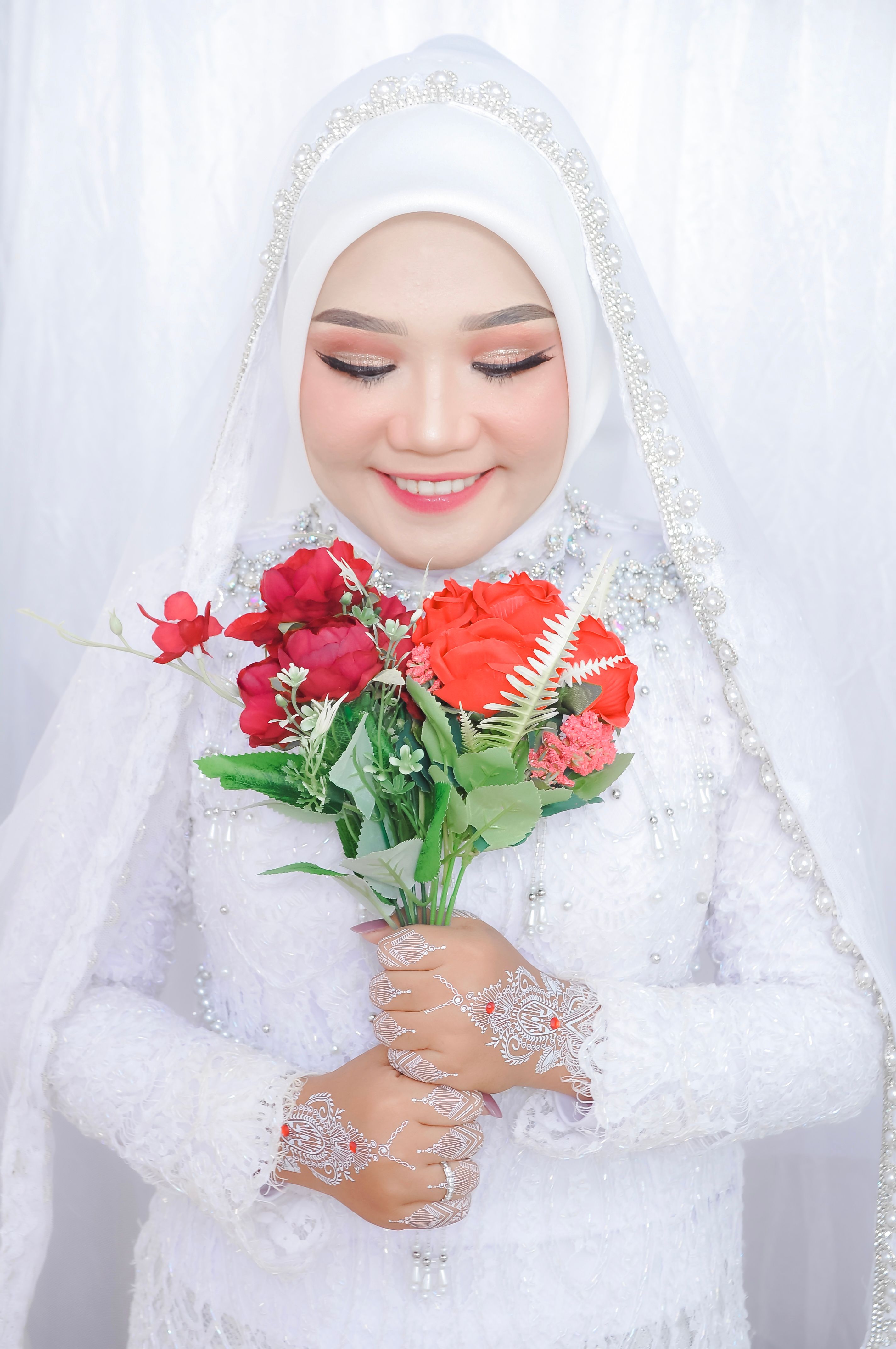 Smiling Bride in White Wedding Dress Holding Bouquet · Free Stock Photo
