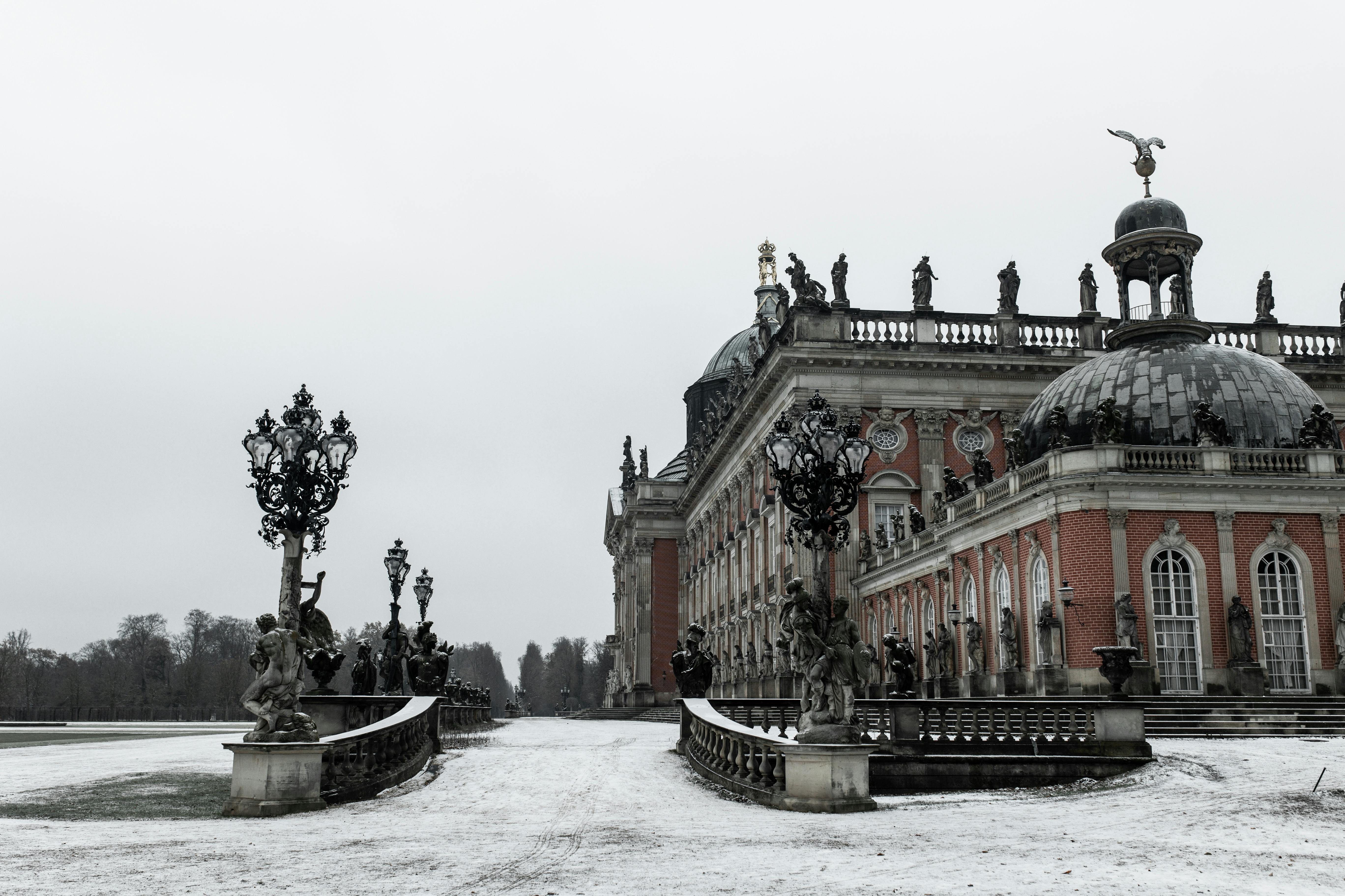 Snow-covered scene of the baroque Neues Palais in Potsdam, Germany, in winter.