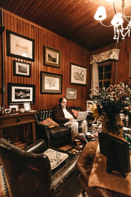 Man Sitting on Sofa with His Laptop