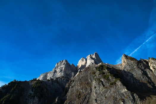 Majestic mountain peaks rise against a deep blue sky, capturing nature's grandeur in Walenstadt, Switzerland.