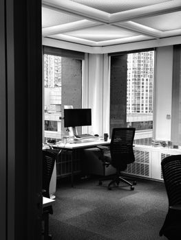Black and white photo of a modern office with city view in Vancouver, BC.