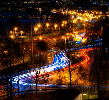 Dynamic city nightscape with vivid light trails capturing motion and energy.