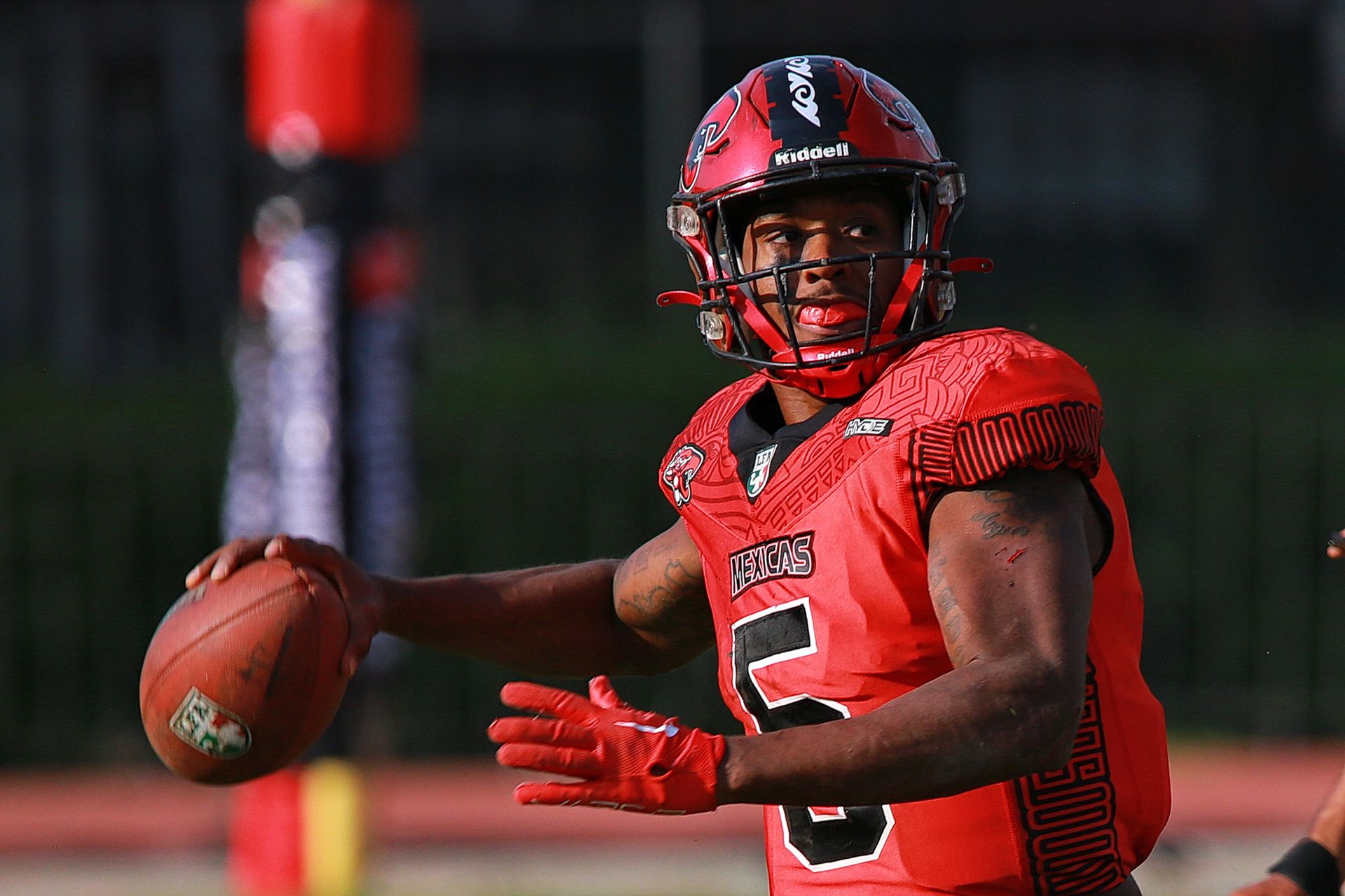 Focused quarterback in action during an outdoor football game, showcasing intensity and skill.