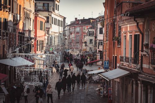 Free Historic Venice street bustling with people and vibrant architecture. Stock Photo