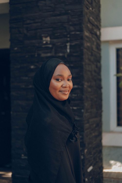 Free Portrait of a woman wearing a hijab, standing outdoors in Abuja, Nigeria. Stock Photo