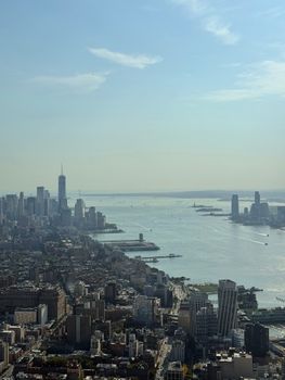 Aerial view of New York City with the Hudson River and skyline on a sunny day.
