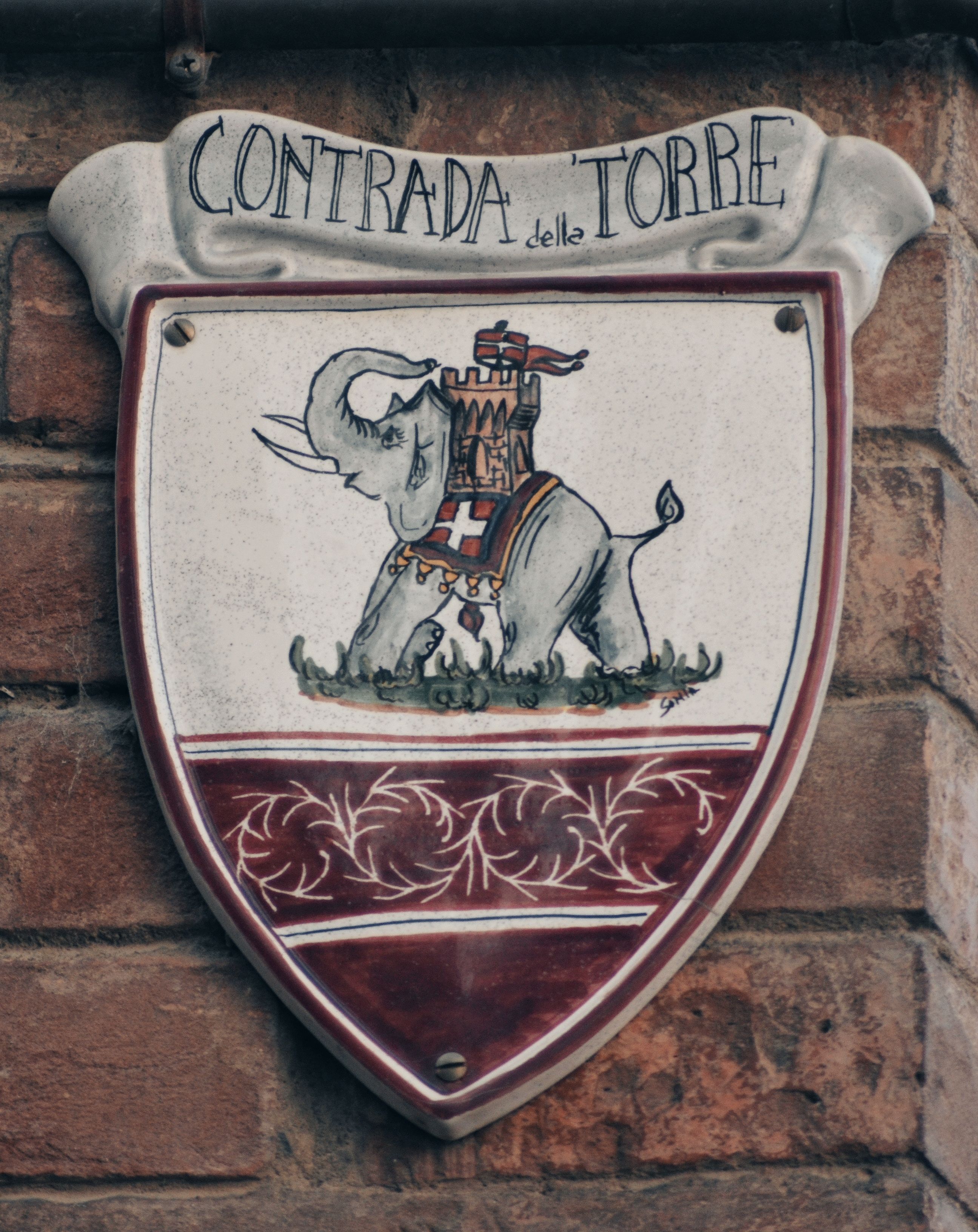 Historic shield plaque of Contrada della Torre in Siena, Tuscany.