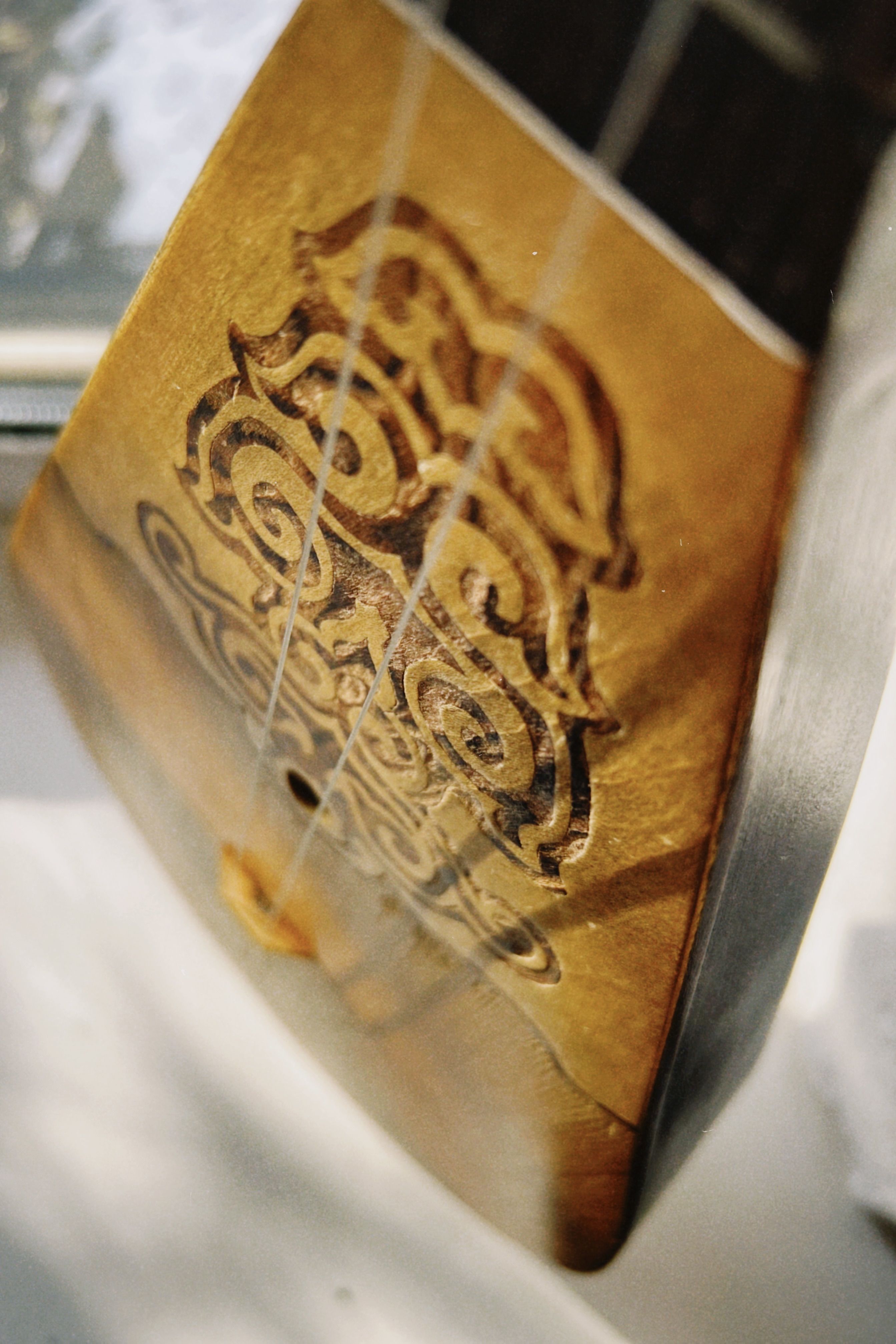 Close-up of a traditional Kazakh dombra highlighting intricate woodwork and craftsmanship.