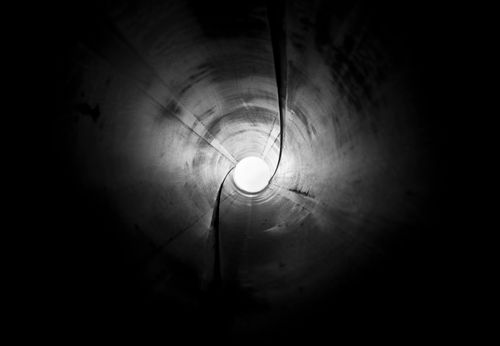 Free A captivating black and white abstract view inside a pipe, creating a tunnel effect. Stock Photo