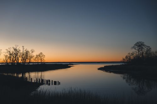 Free Calm waters and vibrant autumn sunrise at Cove Island Park in Stamford, Connecticut. Stock Photo