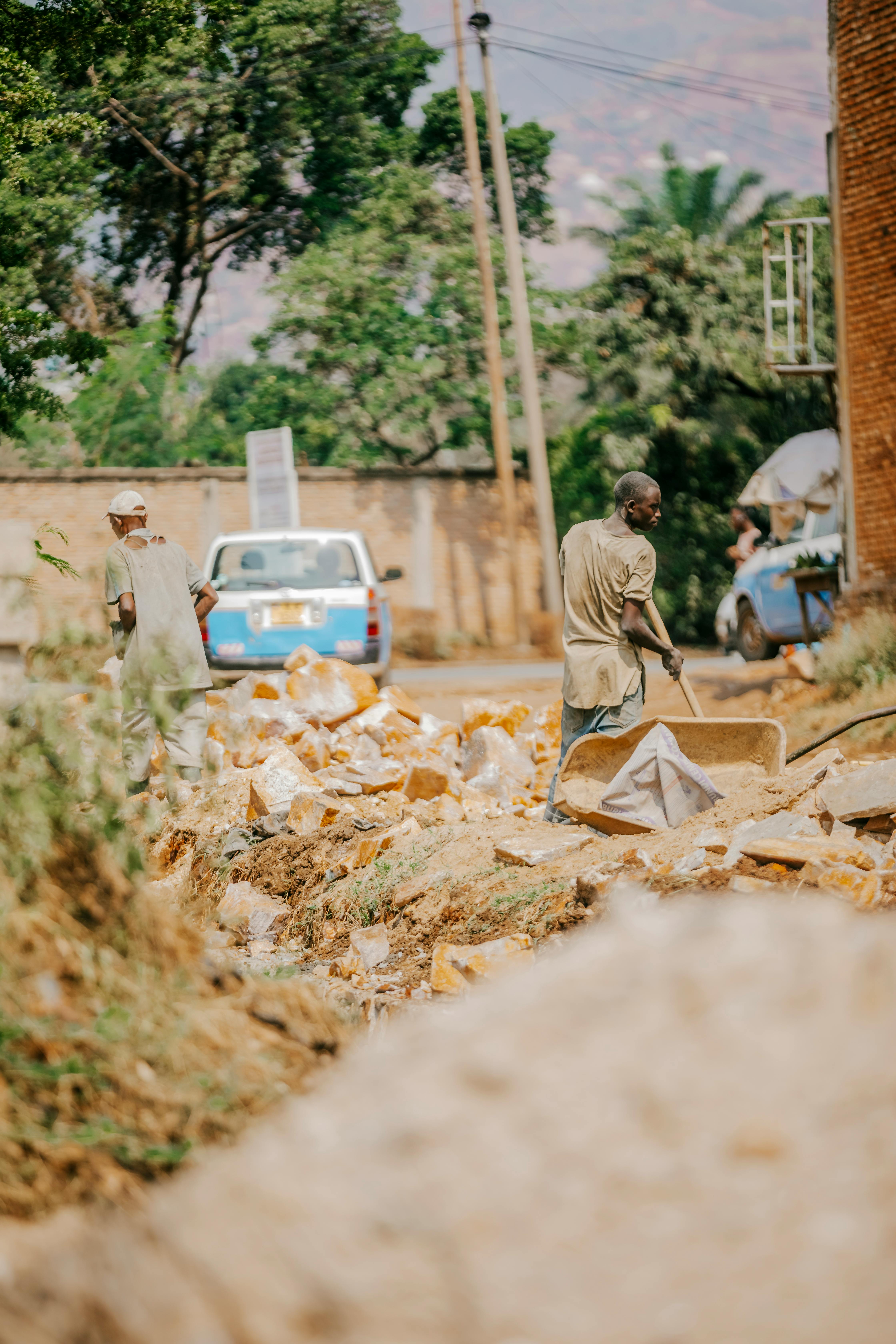 Workers cleaning up street debris in a vibrant urban scene, showcasing community effort.