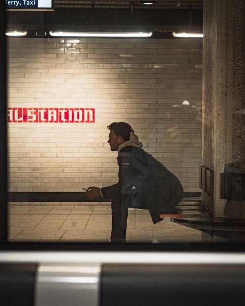 Free A man waits in silhouette at an Amsterdam metro station, capturing urban solitude. Stock Photo