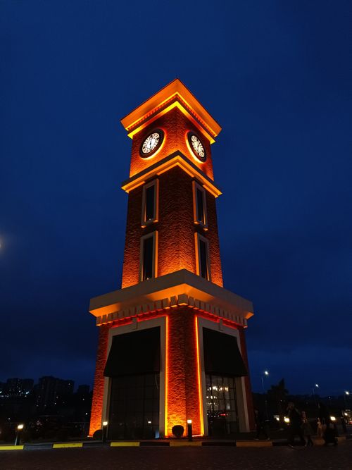 Free Stunning lit clock tower against deep blue night sky, urban backdrop. Stock Photo