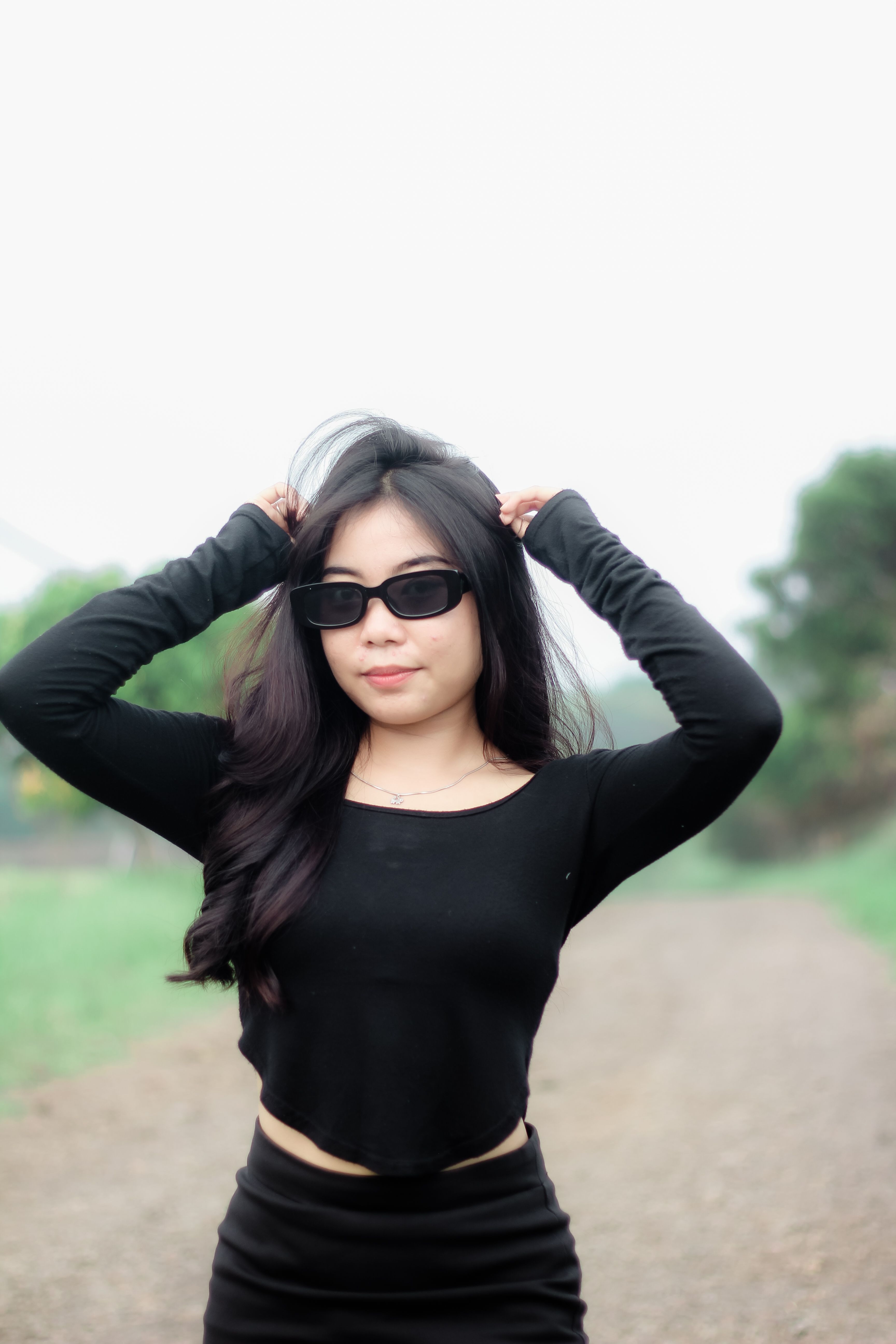 Young Woman in Black Outfit with Sunglasses Outdoors · Free Stock Photo