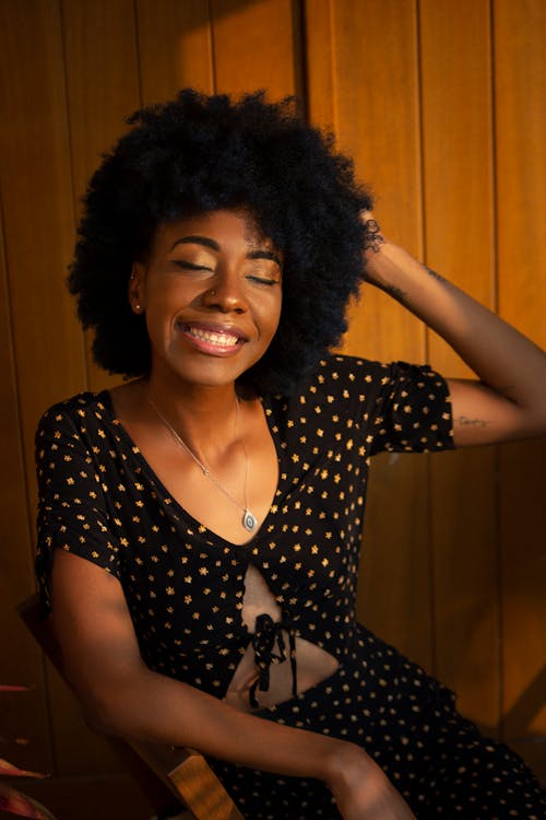 Free Woman Sitting on Brown Chair Stock Photo