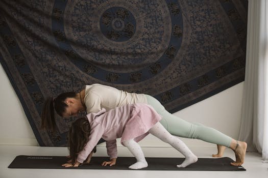A mother and child practicing yoga together indoors, showcasing family bonding and wellness.