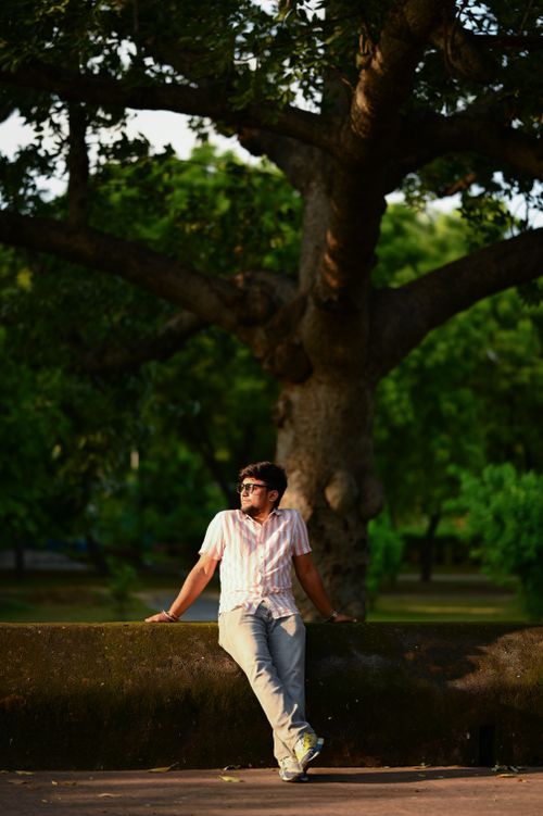 Free A man enjoying a serene moment in a lush New Delhi park during golden hour. Stock Photo