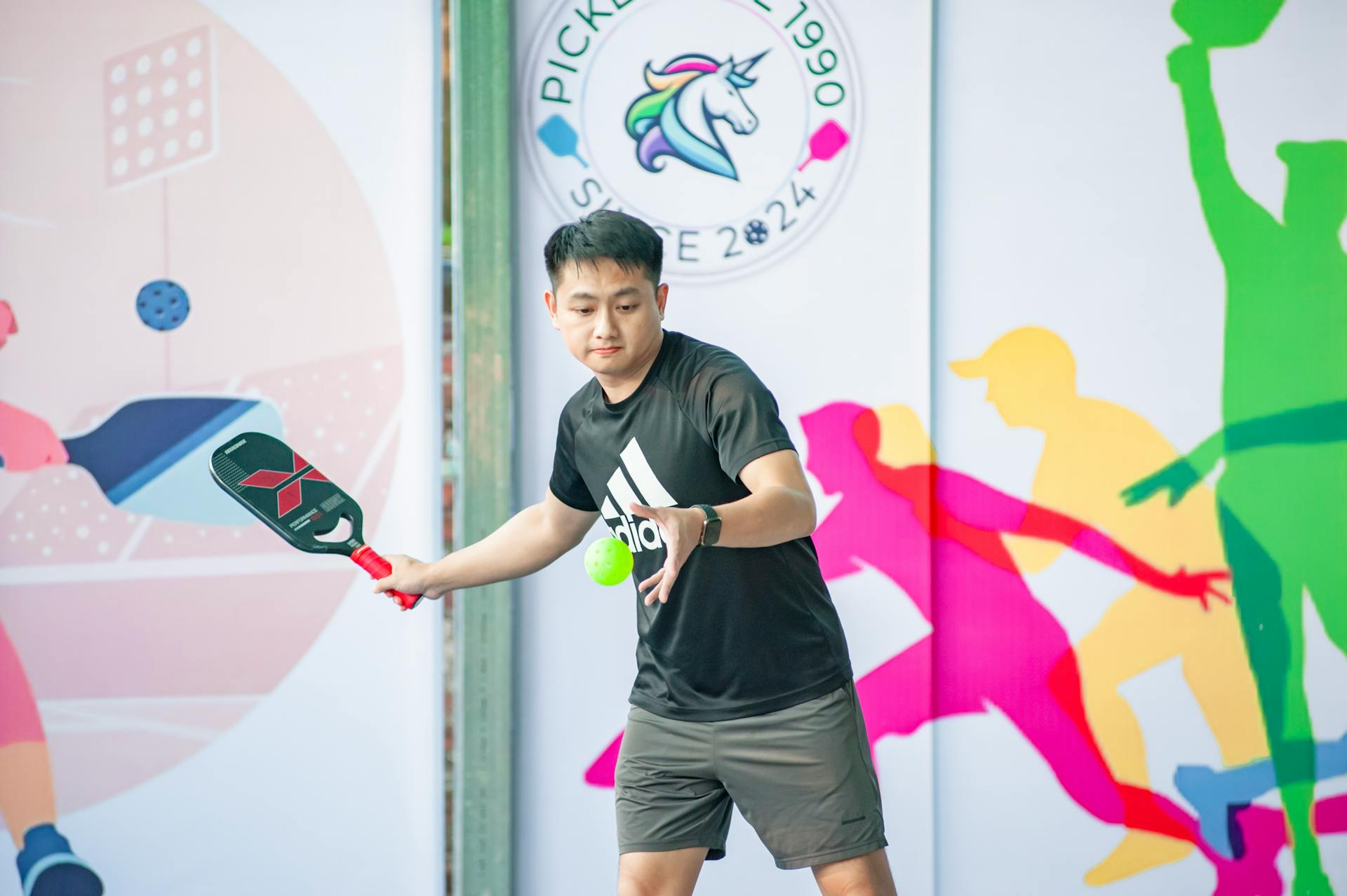 A pickleball player in action during a sporting event in Hanoi, Vietnam.