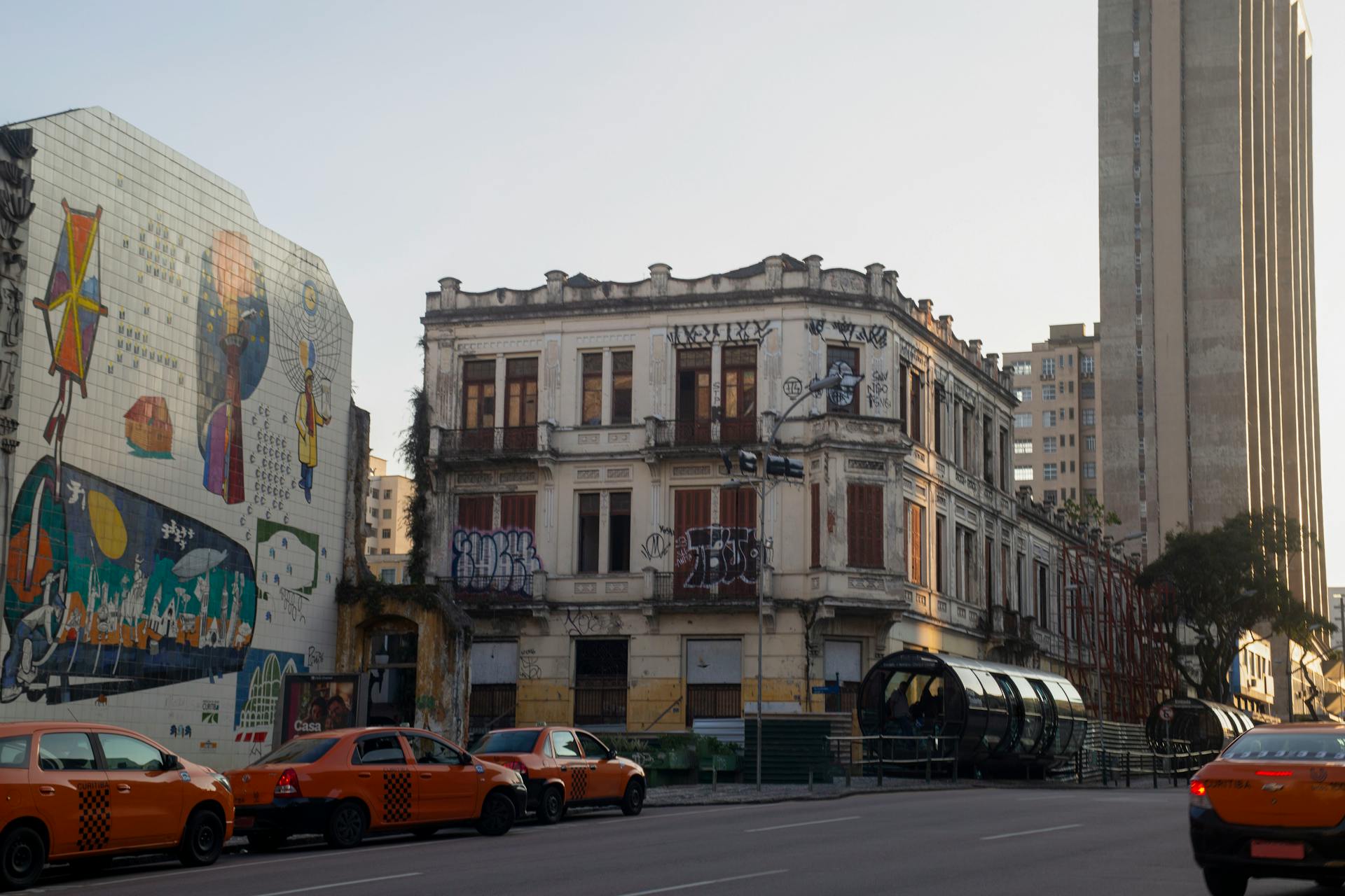 Urban street scene in Curitiba with historic architecture and street art.