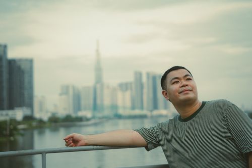 Free Individual overlooking Ho Chi Minh City skyline, calm urban scene. Stock Photo