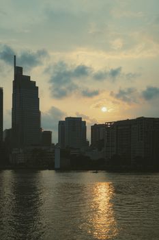 Silhouetted skyline of Ho Chi Minh City during a serene autumn sunset.