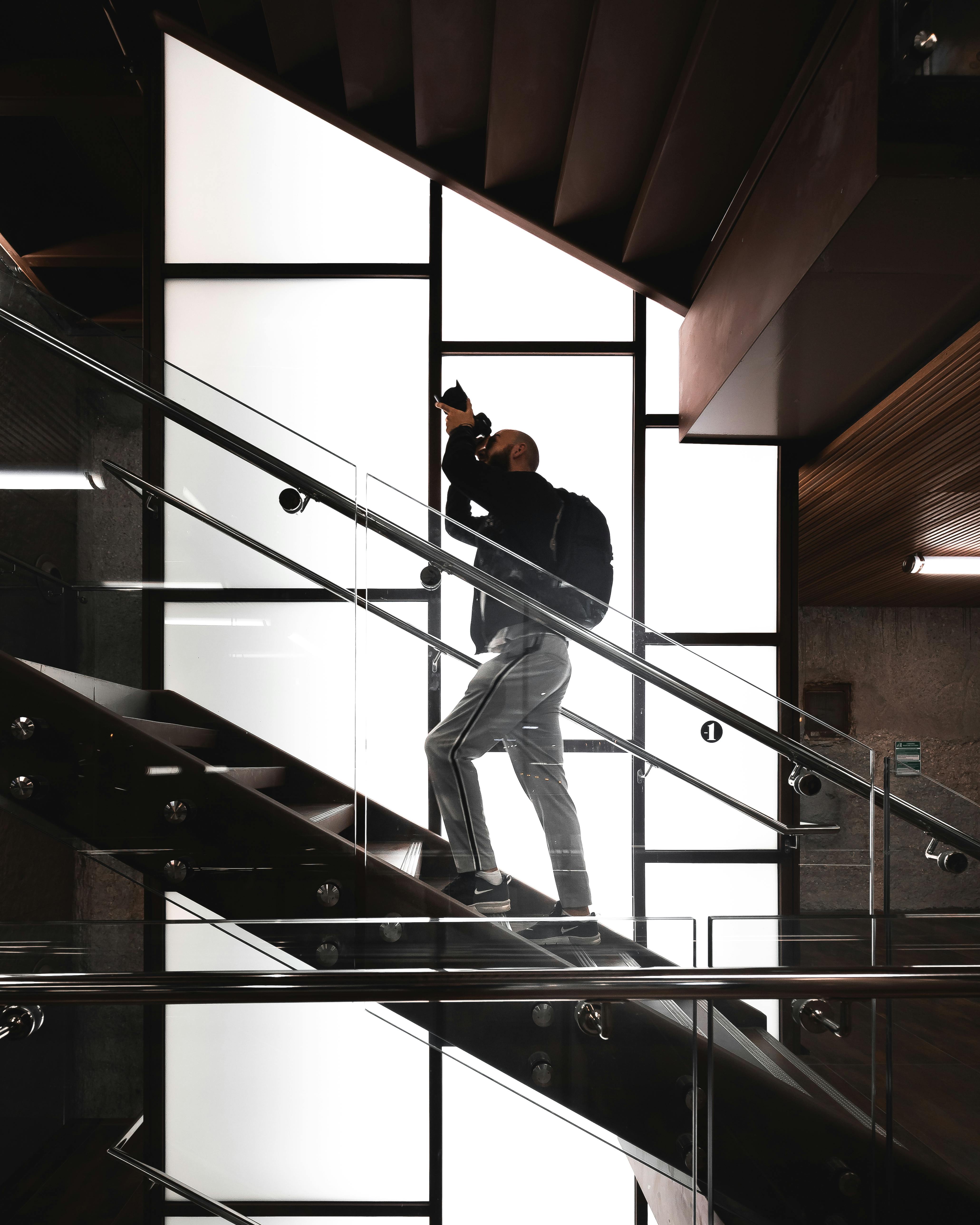 Man Standing on Stairs Holding Camera