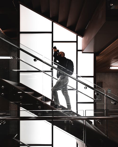Homme Debout Sur Les Escaliers Tenant La Caméra