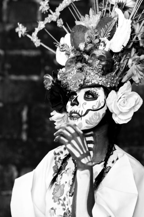 Free Catrina in Mexico City showcasing traditional makeup and elaborate headdress for Day of the Dead celebration. Stock Photo