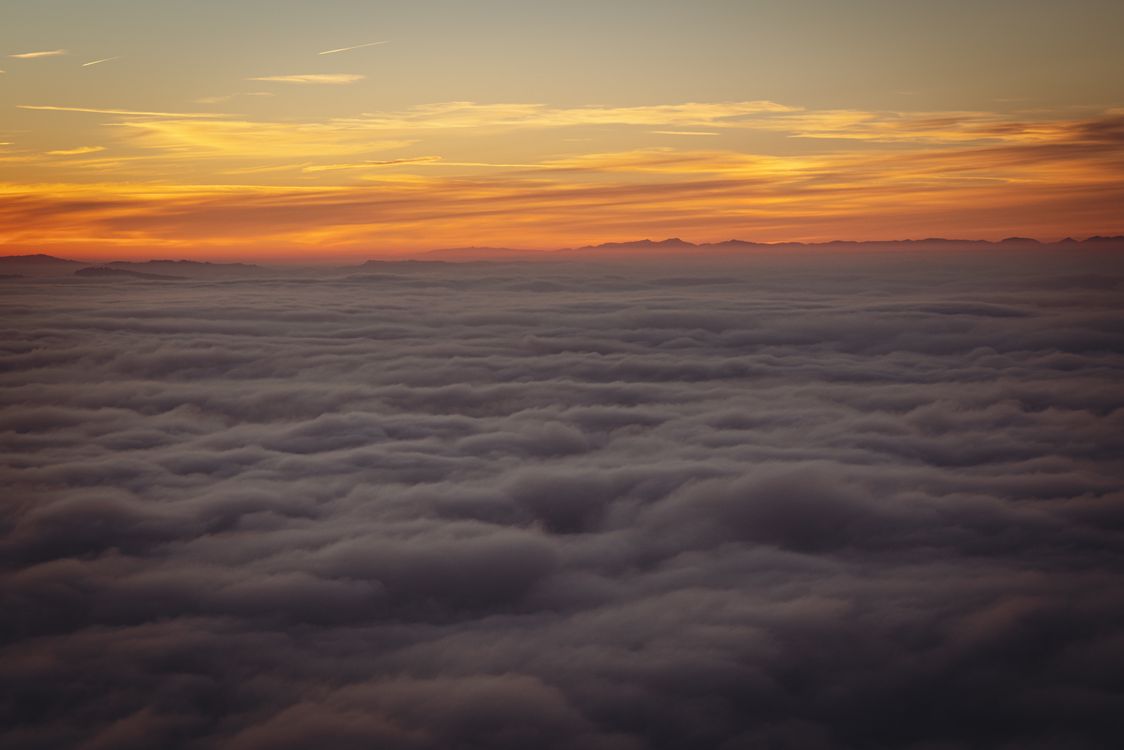 Stunning Aerial View of Sunset Above the Clouds · Free Stock Photo