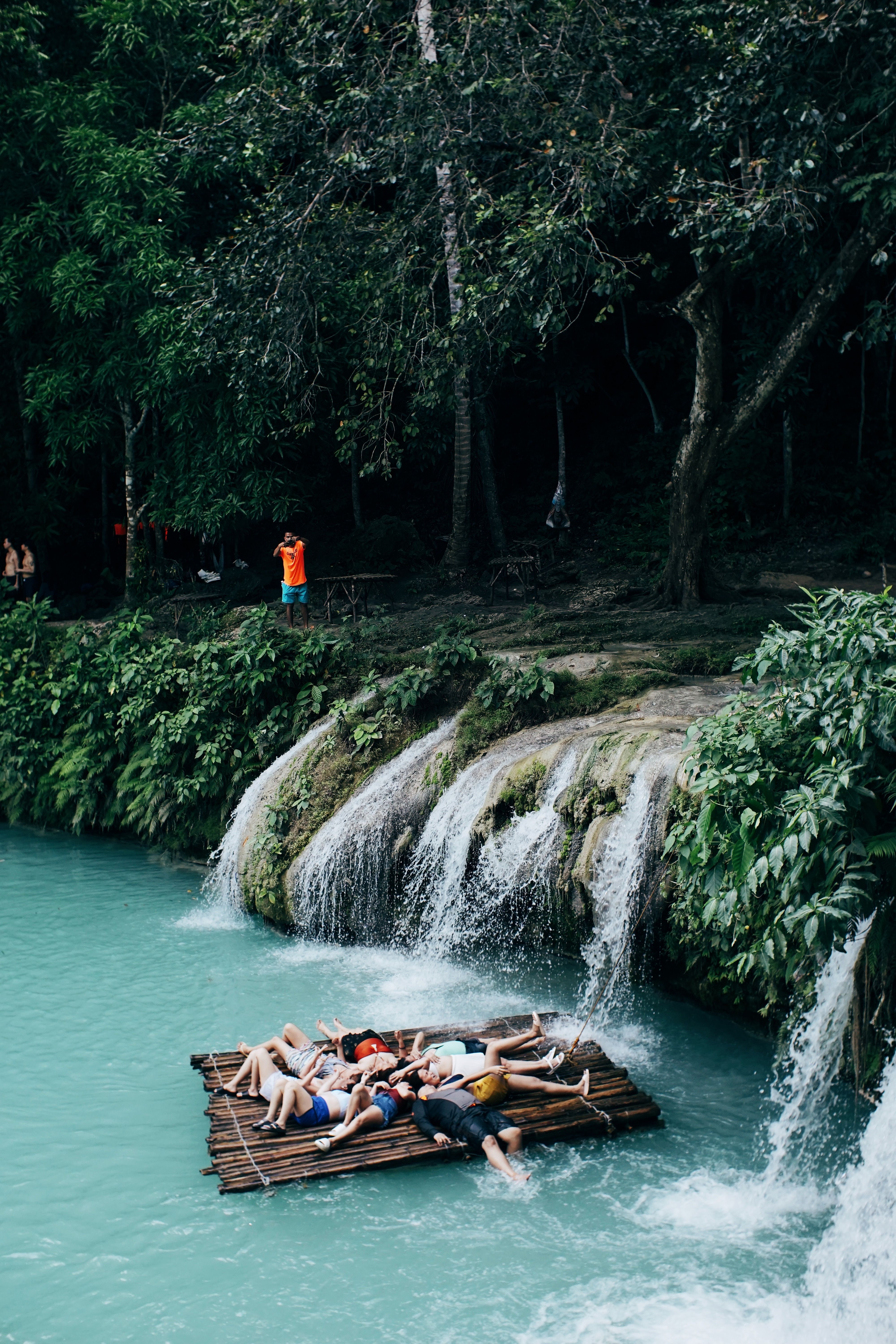 Relaxing on a Bamboo Raft by a Tropical Waterfall · Free Stock Photo