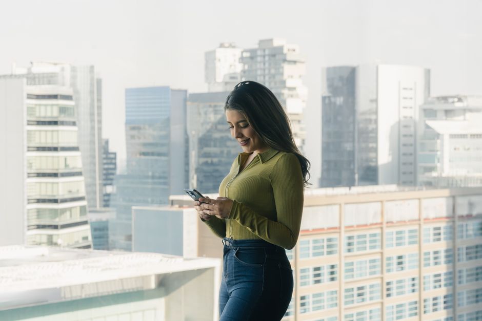 Tourist navigating Panama City using a smartphone with a local SIM card