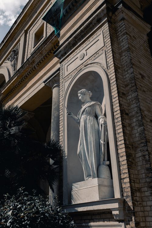 Free Neoclassical statue embellishes historic building facade in Potsdam, Germany. Stock Photo