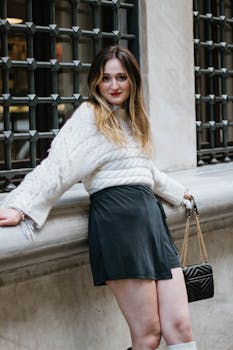 A fashionable woman poses confidently on a street in İstanbul, Türkiye.