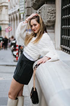 Woman in chic outfit poses confidently on an Istanbul street, showcasing urban style.