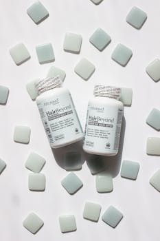 Close-up of HairBeyond vitamin bottles surrounded by tiles, ideal for hair and nail health.