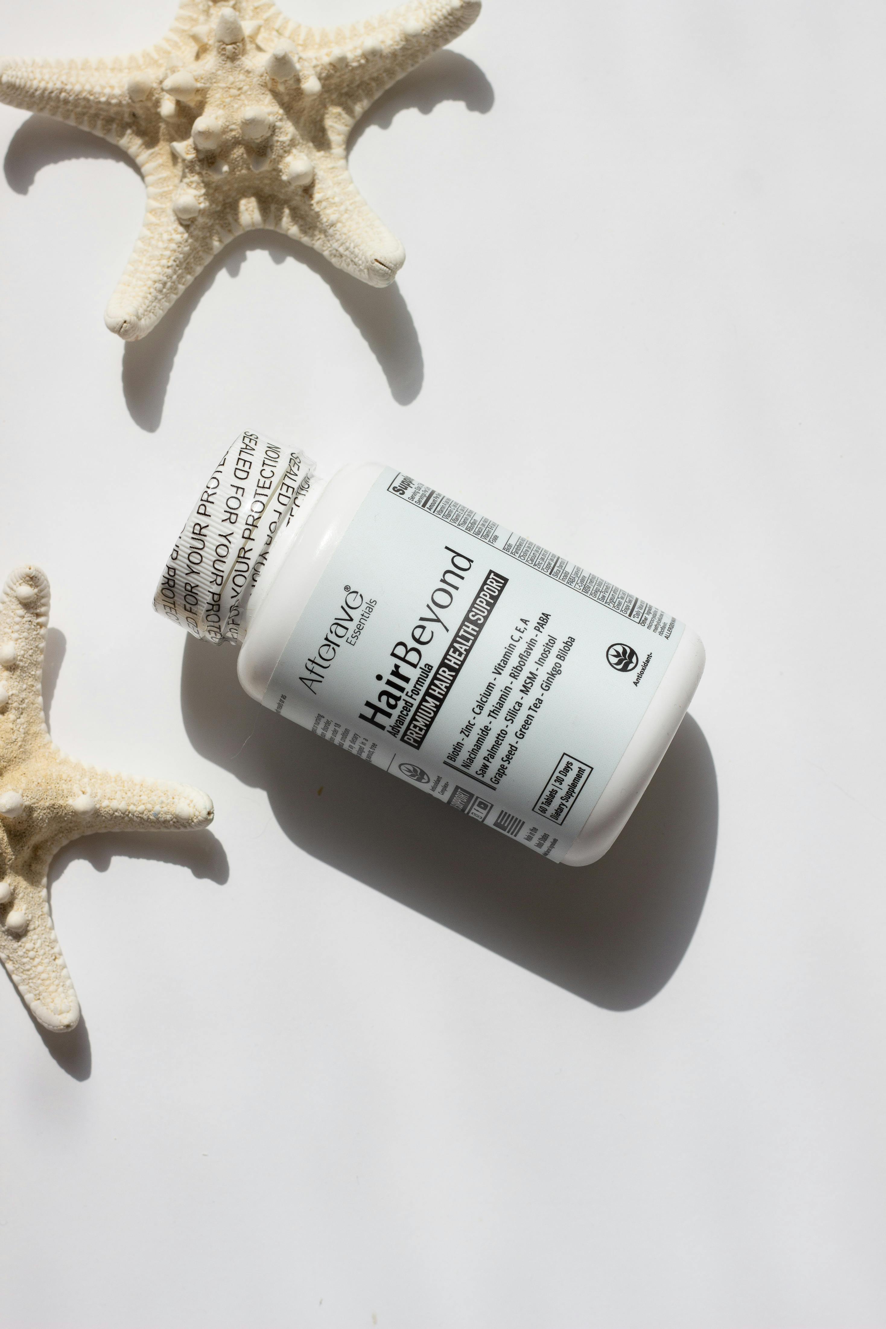 Hair-focused vitamins against a serene starfish background for oceanic vibes.