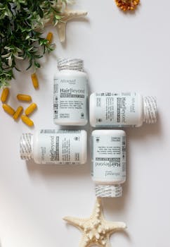 Hair growth supplement bottles and capsules with greenery and starfish decor.