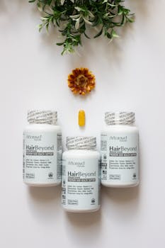 Flat lay of hair health supplement bottles with marigold and foliage.