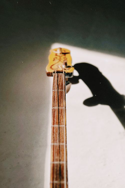 Dombyra Musical Instrument in Sunlight Shadow · Free Stock Photo