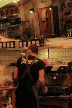 Barista working at an espresso machine in a warm, inviting café setting, creating a charming atmosphere.