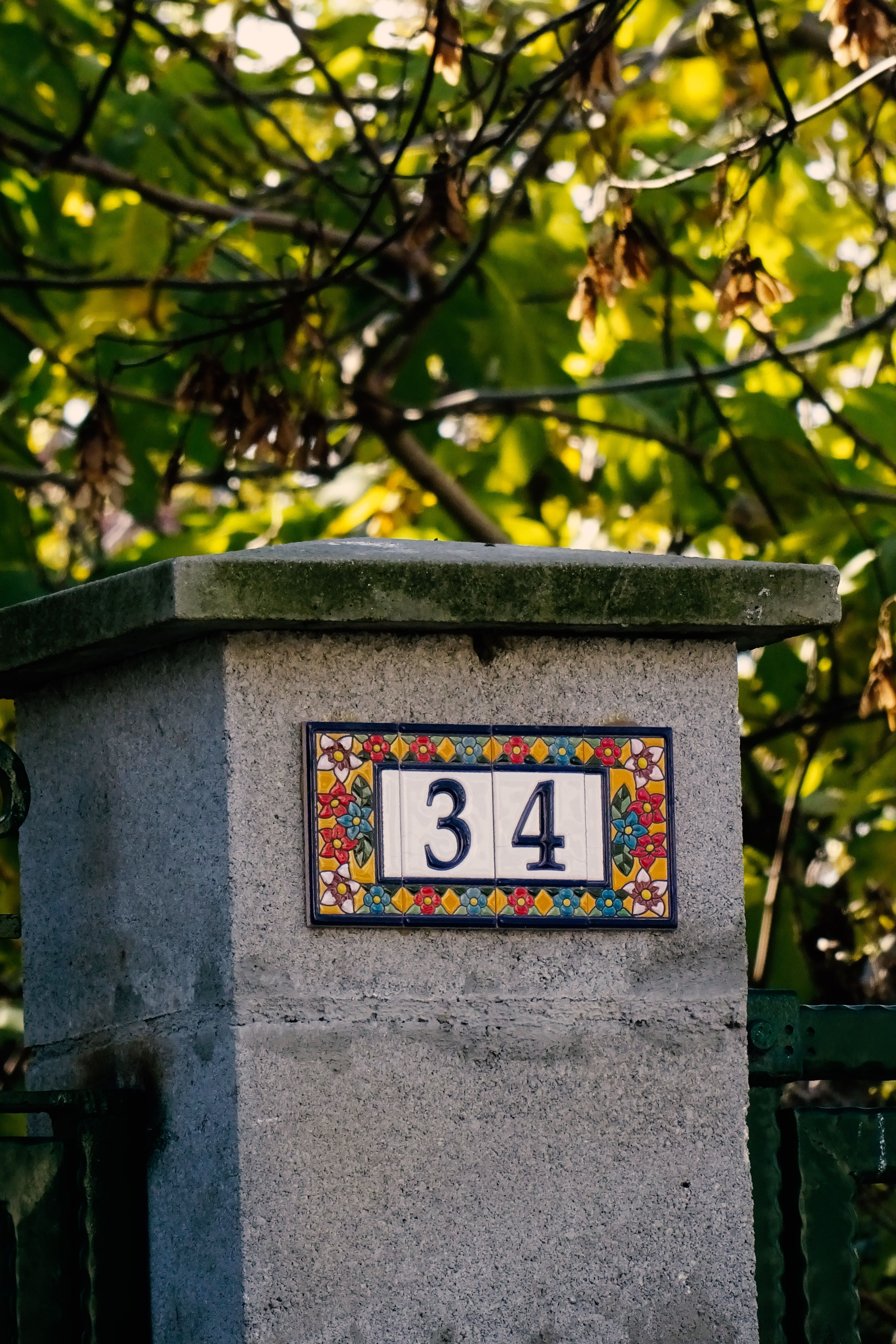 decorative house number on stone pillar outdoors