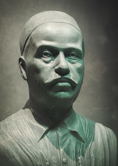 Free Elegant green marble bust of a historical figure with a mustache, showcased in a soft light. Stock Photo