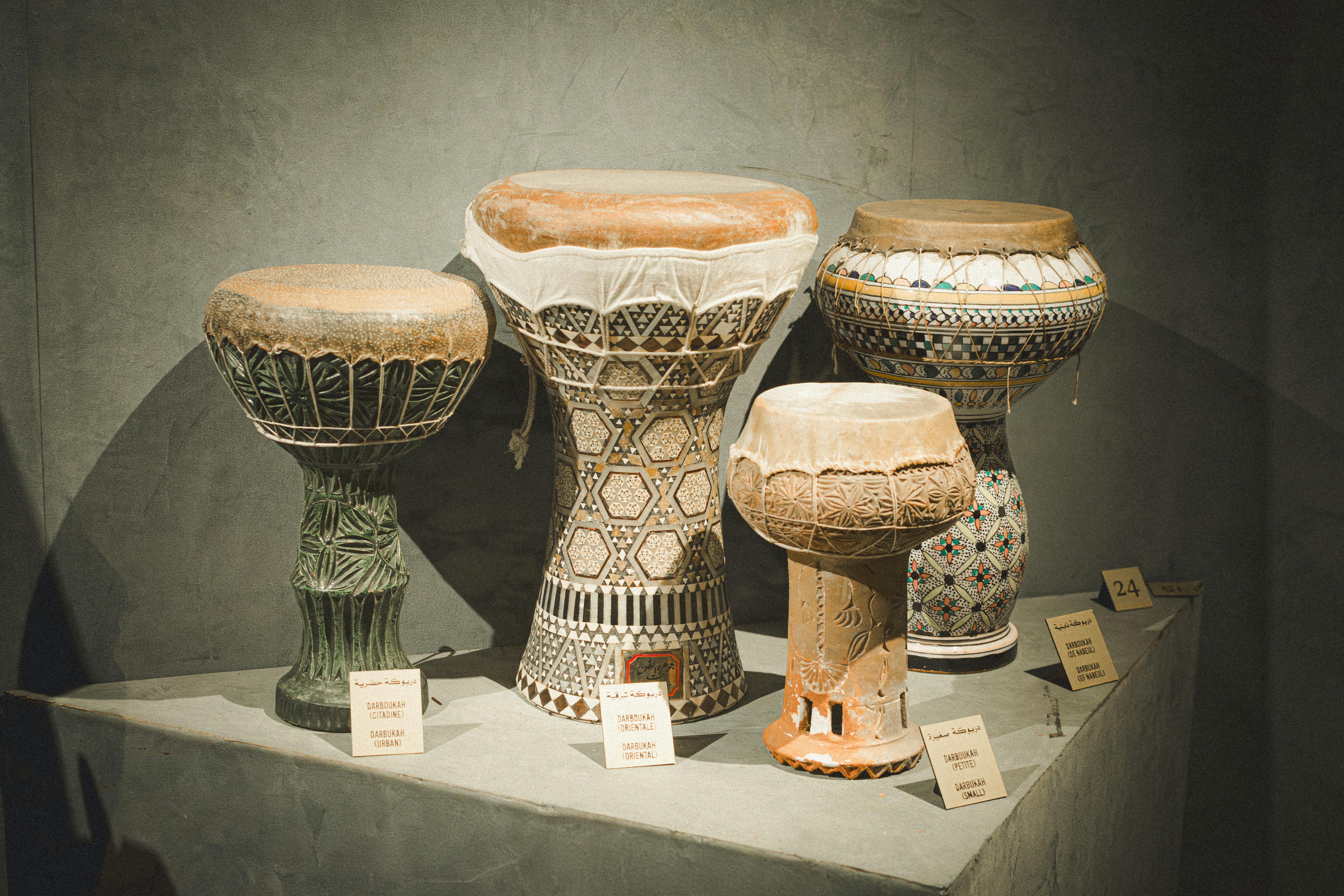 Cultural display of intricately designed Tunisian ceramic drums at a Tunisian museum.