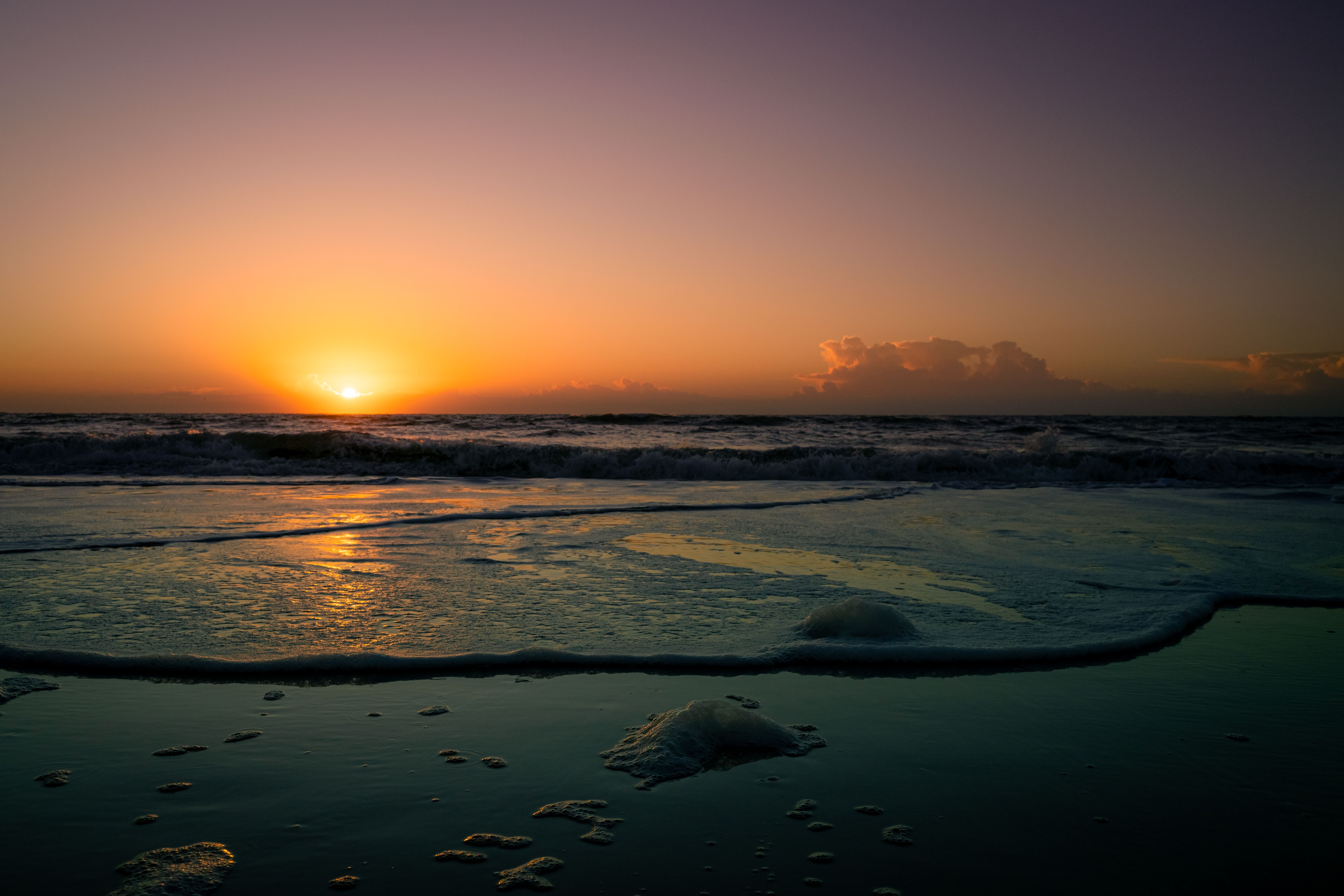 Vibrant Sunset Over Ocean Waves at Beach · Free Stock Photo