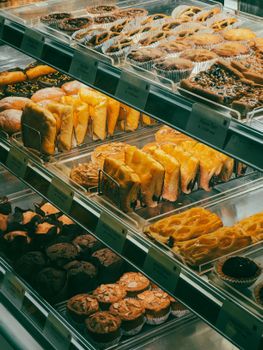 A vibrant display of assorted fresh baked goods in a bakery showcase.