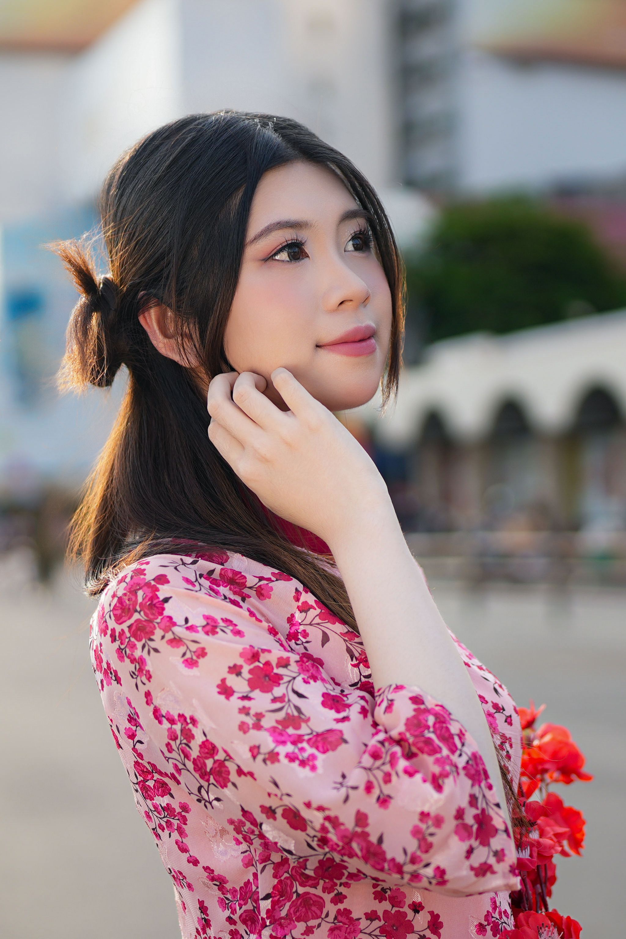 Portrait of a Young Woman in Floral Dress Outdoors · Free Stock Photo