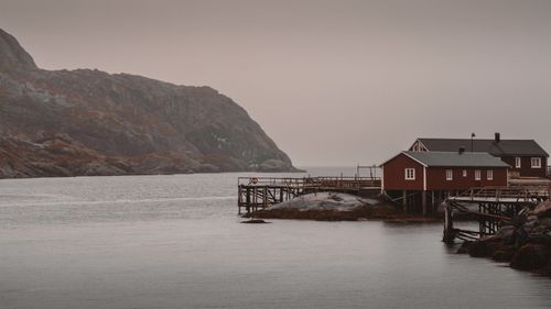Free Red wooden houses on stilts in Lofoten, Norway under overcast sky. Stock Photo
