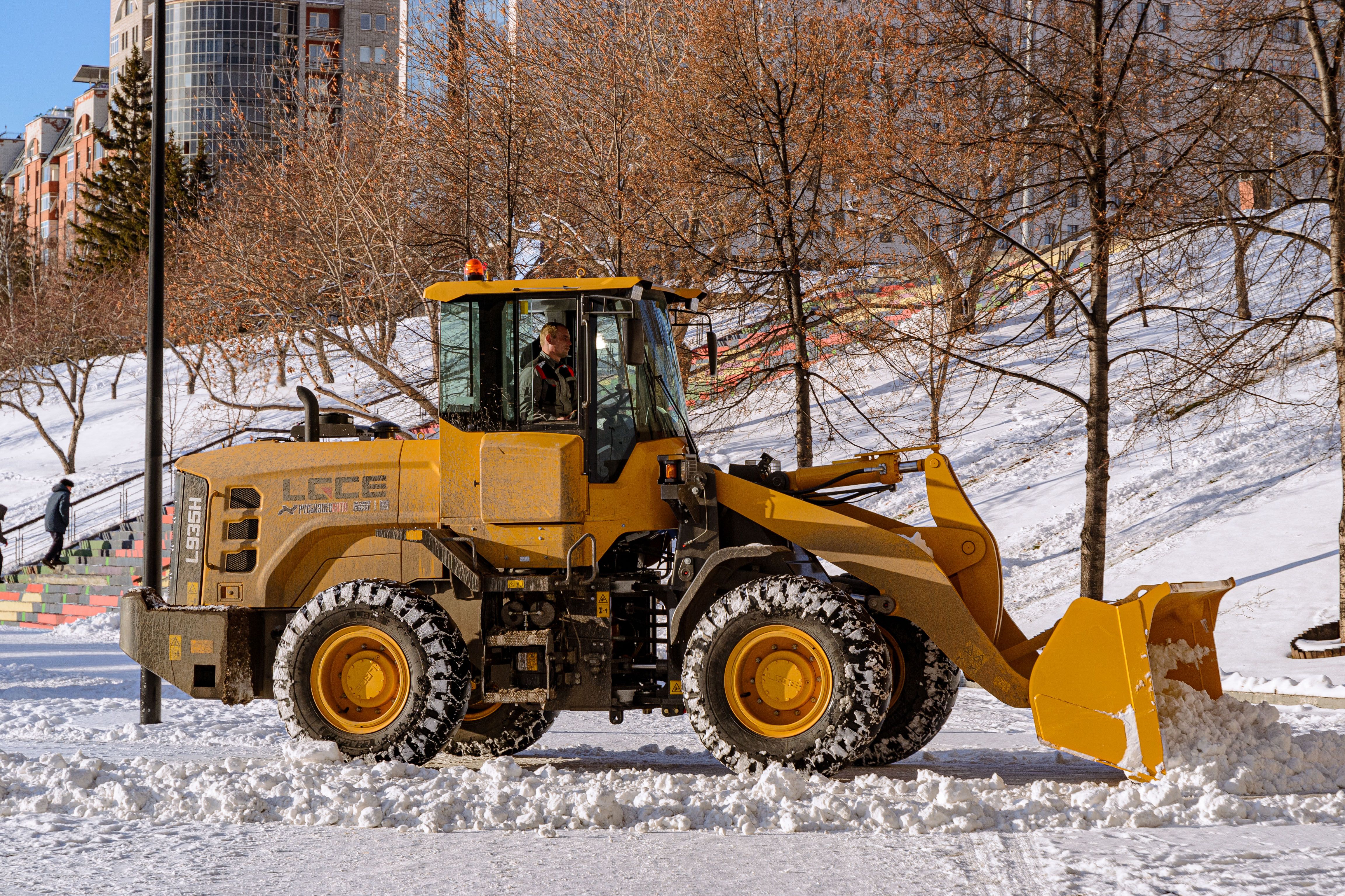 Yellow Bulldozer Clearing Snow in Urban Setting · Free Stock Photo